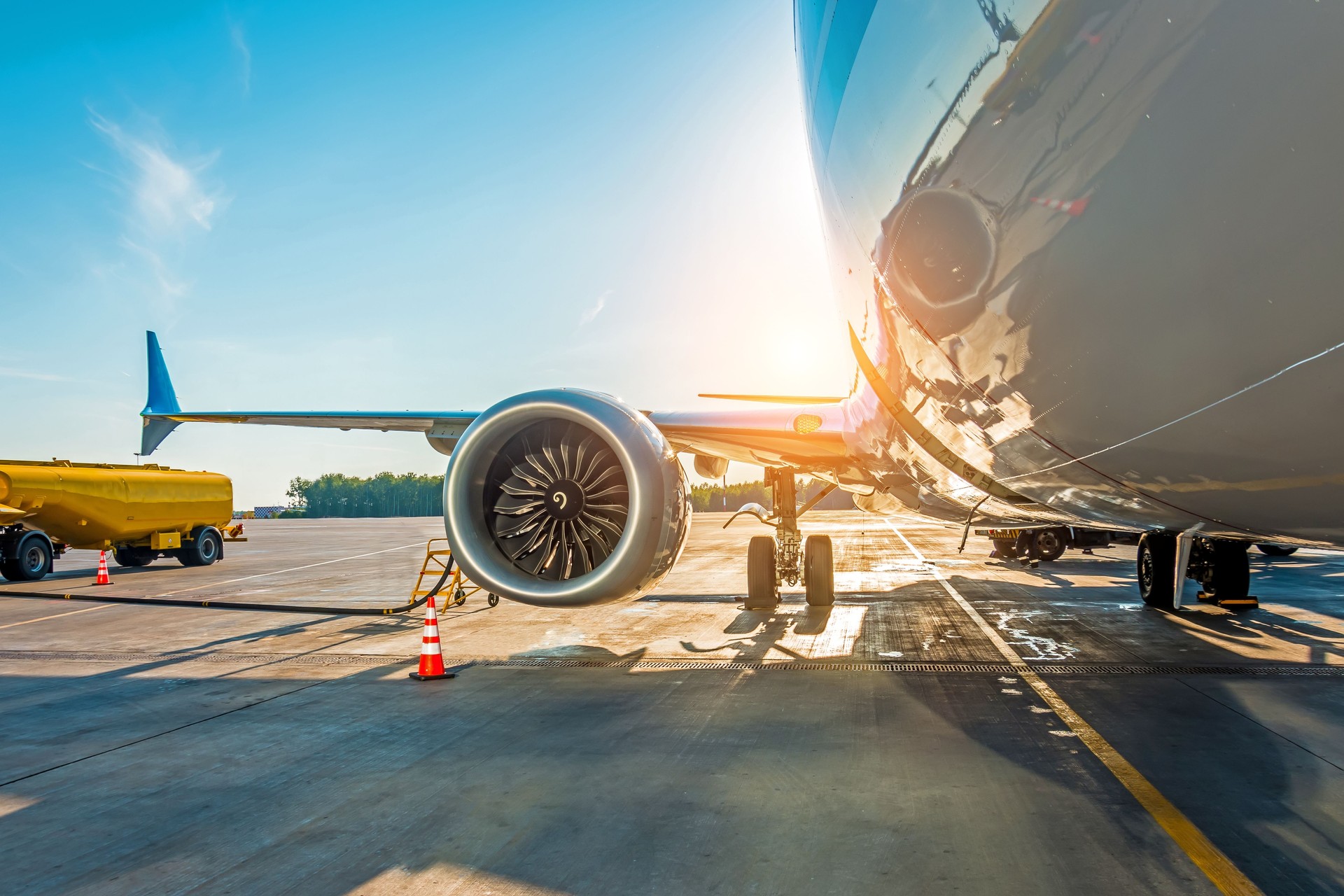 Sunset at the airport. Refueling of the airplane before flight, aircraft maintenance fuel at the airport.