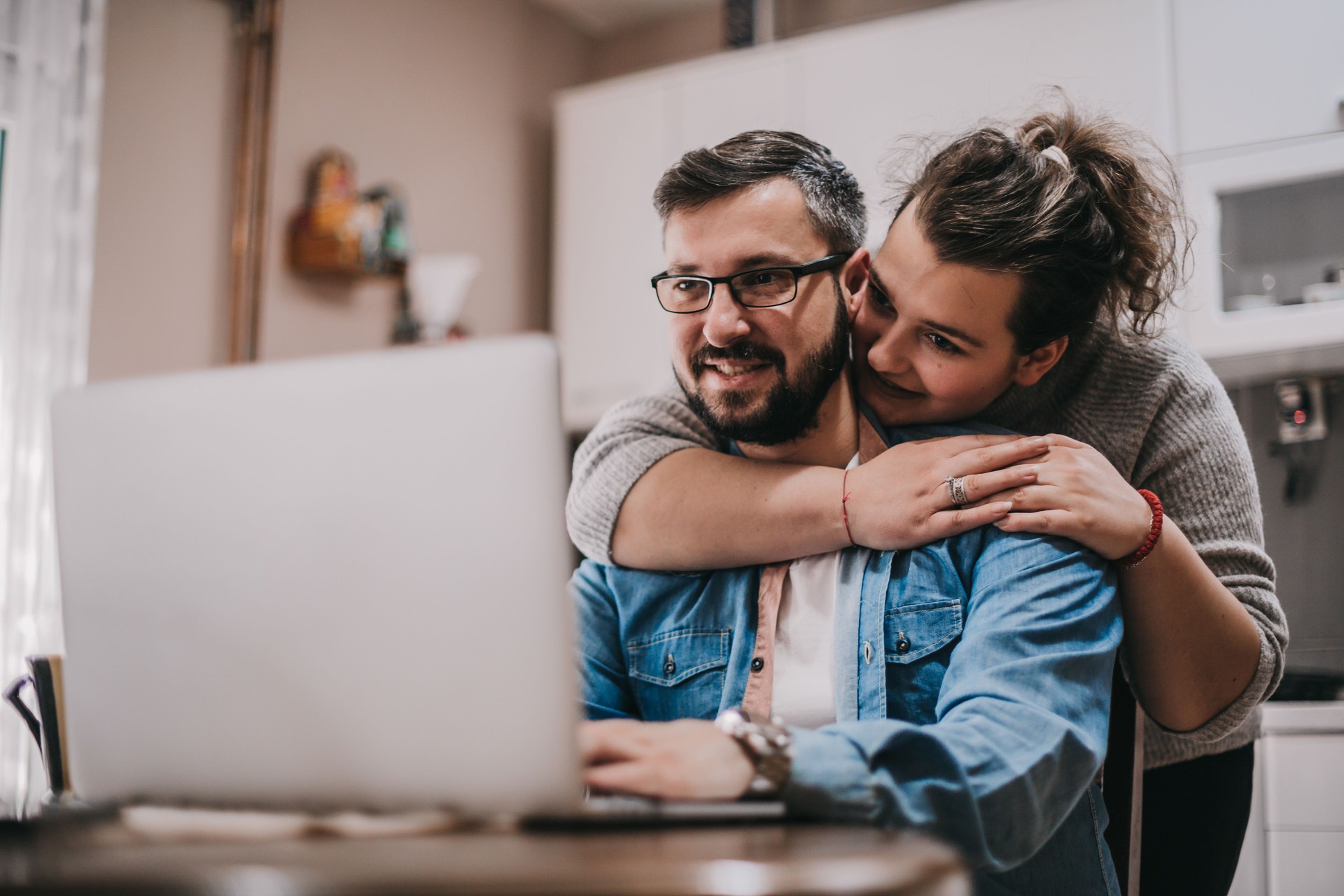 Happy young married spouse making purchases online