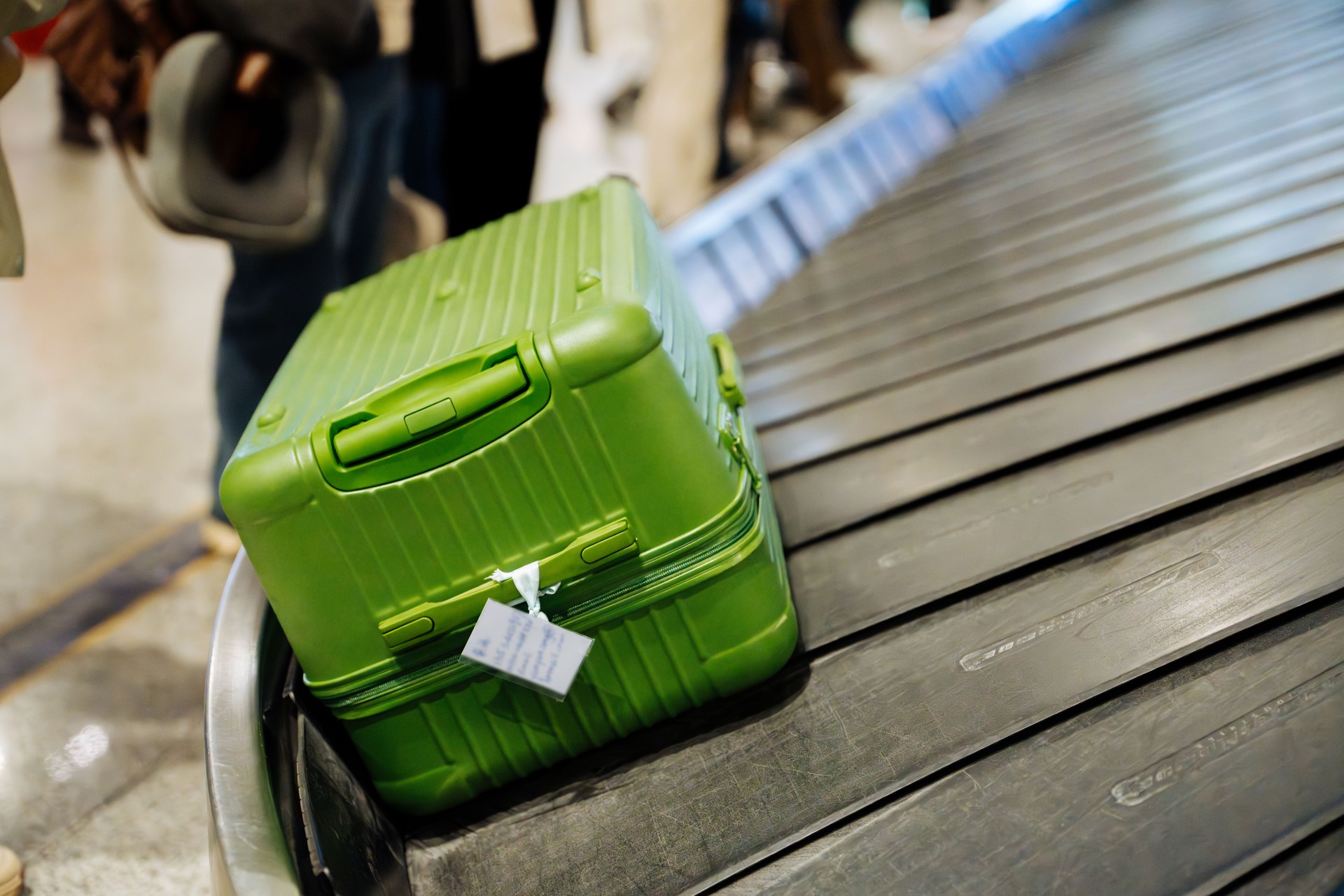 Close up of luggages moving on airport conveyor belt at airport. Green series.